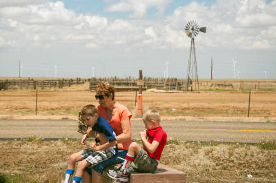 Cherri and the boys in Texas - new and old windmills.